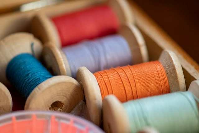 thread spools in wooden bobbins